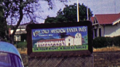 1962: Visit Old Mission Santa Ines spanish historic site sign.