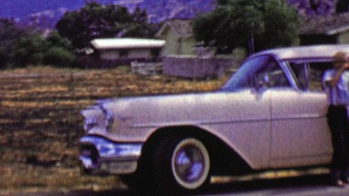 1962: Pink cadillac car roadside stop kid celebrates epic photo.