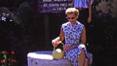 1962: Mature women taking break touring Santa Ines Mission.