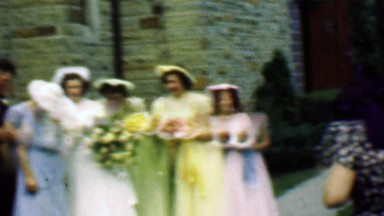1961: Wedding party rainbow colorful bridesmaids dress outdoor pose.