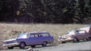 1967: Campers parking cars on gravel road prepare for trip.