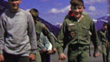1967: Boy Scout rascal squad marching mountain forest area.