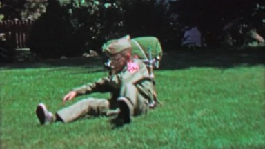 1967: Boy scout full outfit garb heavy backpack prepares camping trip.