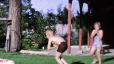 1967: Kids dive into backyard kiddie pool in slow motion.