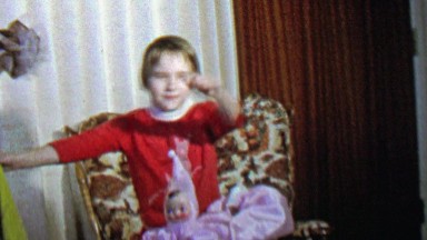 1967: Young magician girl performs disappearing doll trick.
