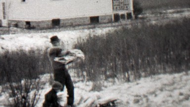 1939: Homeless man newspaper collection moving sleep camp.