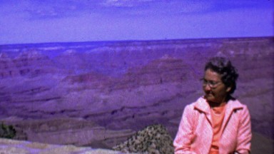 1964: Senior pink suit jacket woman posing grand canyon.