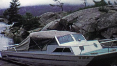 1961: Boat Closeup Docked in Rocky Calm Hidden Gentle Bay Cove