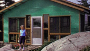 1957: Woman Stands Outside Summer Lake Vacation Home