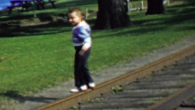 1957: Kid walking railroad balancing risk taker wild child.