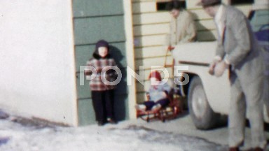 1957: Family baby cart red sled wheels pushing happy baby stroller.