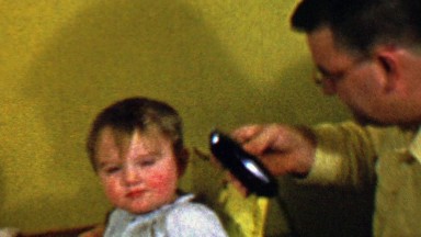 1957: Dad cuts bold baby hair with electric buzzers shaves head.