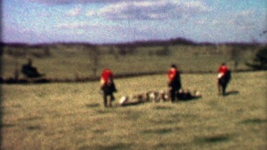 1958: Horse Riding Fox Hunt Pack Dogs Follow Red Jacket Hunters.