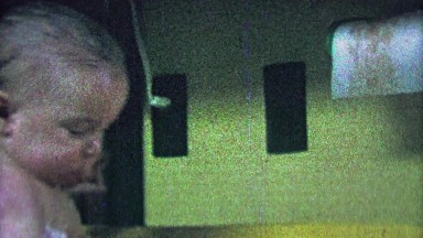 1967: Determined Baby Splashing Water in Tub with Yellow Inflatable Toy