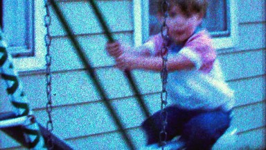 1967: Confident Boy Swings High on Swing Set Too Close to House