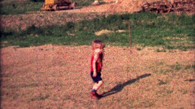 1968: Toddler boy practices baseball throw fielding grounders.