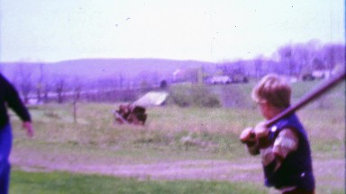 1968: Dad pitching boy baseball practice in rural farm country.