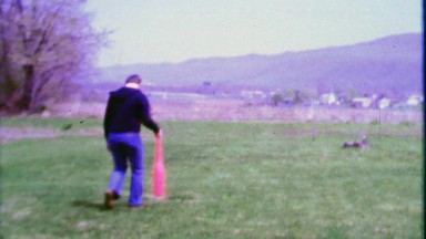 1968: Dad swings wiffle baseball bat hits ball showing kids how it's done.