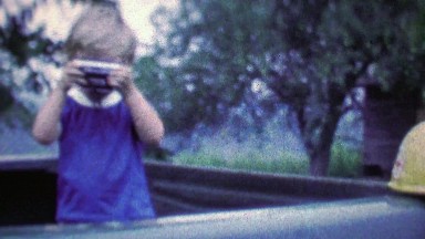 1968: Young boy photographer in the making clowning with camera.