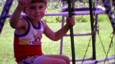 1968: Cute bowl cute boy waves from summer playground set.