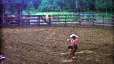 1955: Fancy rodeo cowboy lasso rope work jumping thru spinning hazard.