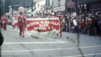1954: Scotia Glenville marching band parading downtown festival.