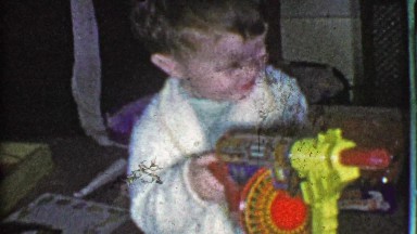 1953: Boy shoots futuristic windup toy tommy gun Christmas morning.