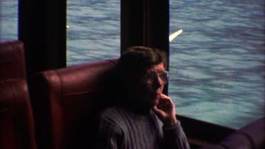 1974: Lonely Woman on Train Looks Out Window, Smiles and Waves