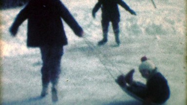 1957: Kids ice skating swing boy on winter snow sled playtimes.