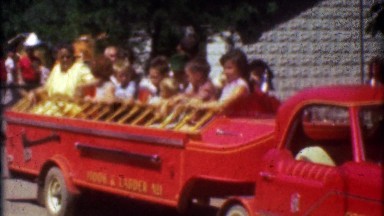 1957: Kids riding mini firetruck ride at Catskill Game Farm zoo.