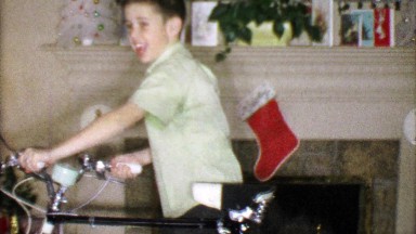1963: Boy loves ten speed bike Christmas gift in family room.