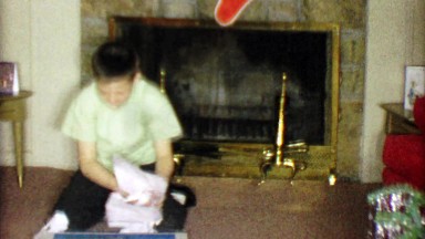 1963: Boy unwraps Electrical Build-It-Set learning Christmas gift.