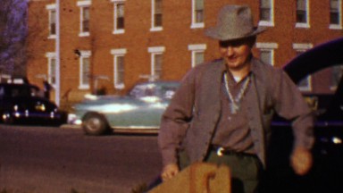1955: Alaskan musician tribal necklace puts instrument into car.