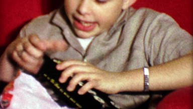 1964: Boy unwraps Xacto knife Christmas gift.
