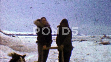 1957: Sled dog mushers taking break from long journey.