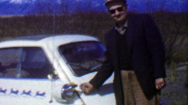 1957: BMW Isetta White Mini Car Man Shows Off Wacky Vehicle