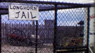 1959: Longhorn Jail kid pretending locked up behind bars.
