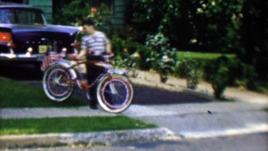1961: Boy Rides USA Flag-Laden Bike Around Suburban Streets