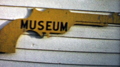 1959: Old Wild West Gun Museum Free Entry Sign and Building