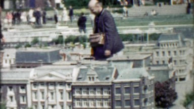 1962: Man Enjoying Realistic Mini Model Wealthy Home Replica Buildings
