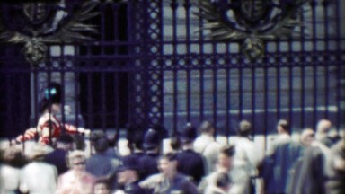1963: Bearskin Royal British Queen Guards protected behind fenced gates.