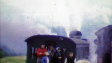1964: Family riding Cog Railway on cloudy steamy gray day.