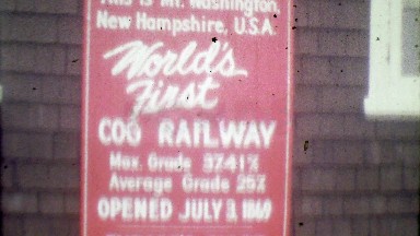 1964: World's 1st Cog Railway sign steam train intersection.