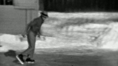 1937: Man ice skating backwards winter flooded backyard rink.