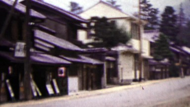 1951: Japanese quiet street woman riding bike in distance.