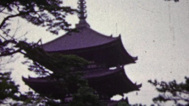 1951: Japanese pagoda temple soothing forested landscape.