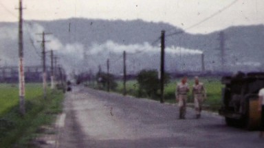 1951: Soldiers exploring Japanese countryside rice fields steamroller.