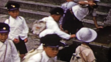 1951: Japanese school kids drinking sacred temple waters before entering.