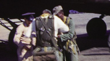 1951: US Military Men Prepare Parachutes Ready for Airplane Boarding.