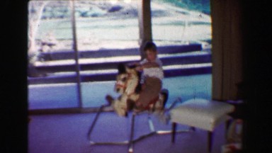 1968: Boy and Girl on Toy Rocking Horse at Country Clubhouse While Dad Plays Golf